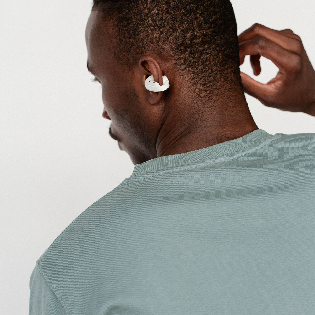 Sudio B3 White earbuds on a female model wearning sunglasses