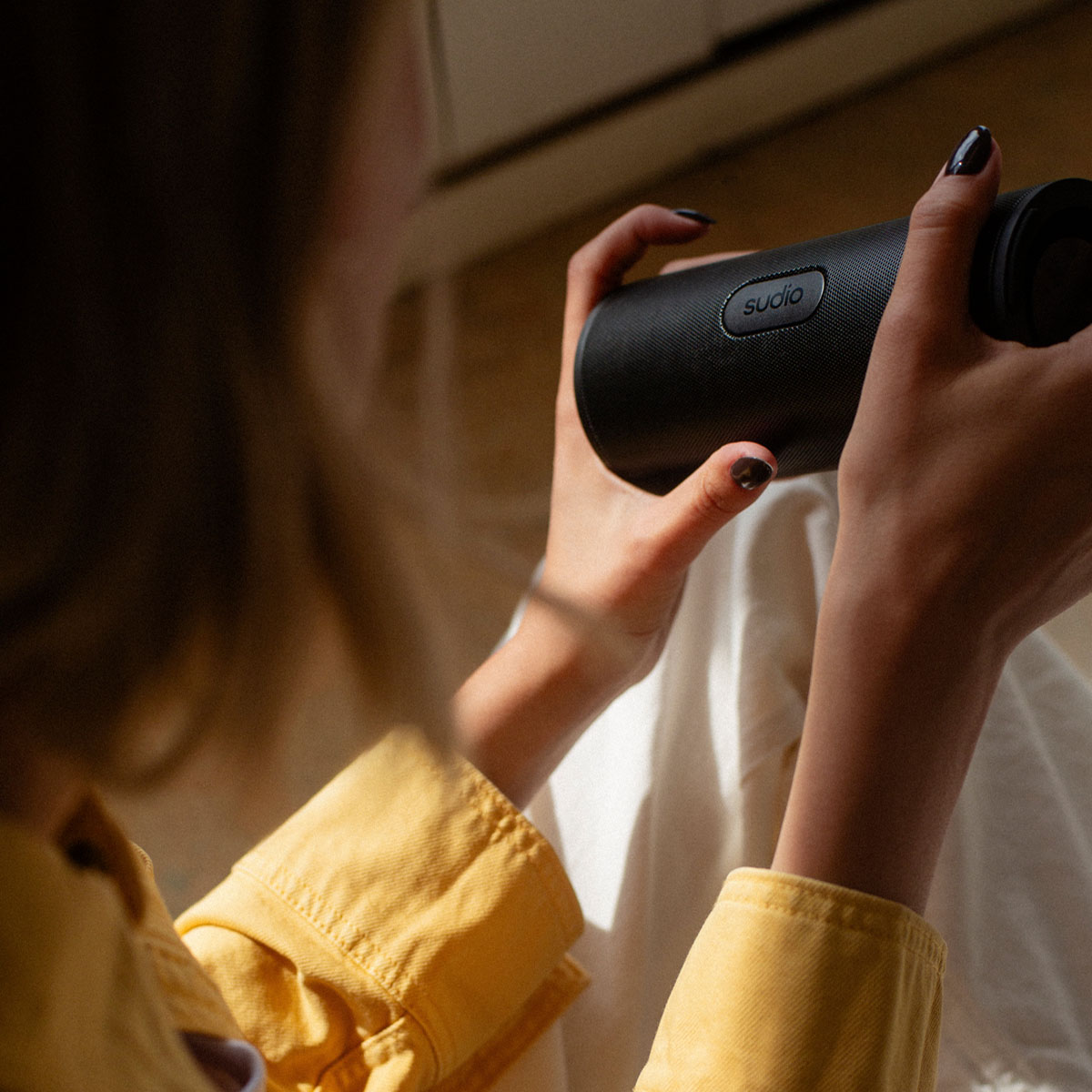 F4 speaker black holded in a hand