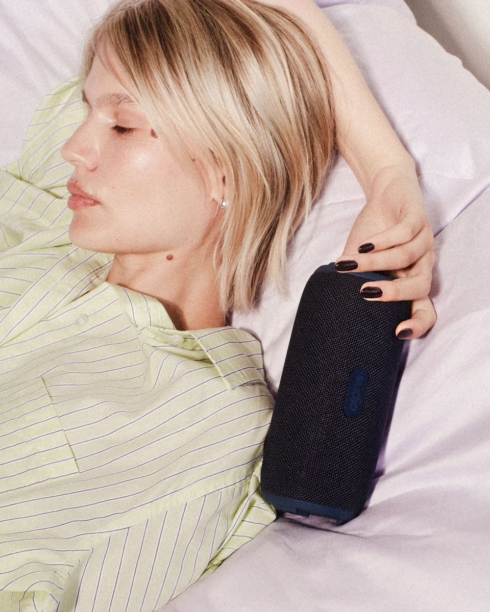 a model holding Sudio F5 potable speaker